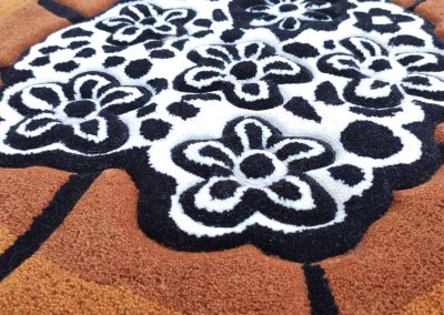 Close-up carving of hand-tufted abstract floral rug
