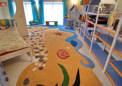 "Panoramic view of custom-designed ocean rug from the sleeping corner"