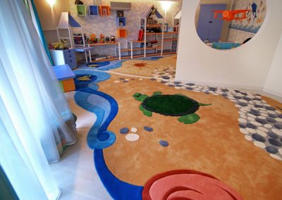 "Custom ocean-themed kids rug with turtle and abstract seaside design in play area" width="100%"